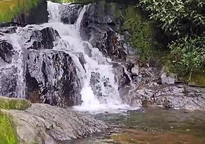 A black man with a large penis has rough sex with a white twink with a pierced ass while at the waterfall